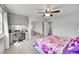 Bedroom featuring closet doors with mirrors, built-in desk area, and floral bedding at 1303 S Danube Way # 104, Aurora, CO 80017