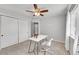 Cozy bedroom featuring neutral walls, a ceiling fan, and a white desk beside the bright window at 1303 S Danube Way # 104, Aurora, CO 80017