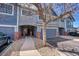 View of the front townhome exterior with brick posts along the driveway at 1303 S Danube Way # 104, Aurora, CO 80017