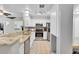 Kitchen area showcases stainless steel appliances, granite counters and light cabinetry at 1303 S Danube Way # 104, Aurora, CO 80017