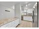 Open-concept kitchen with granite counters, stainless steel appliances, and a pantry at 1303 S Danube Way # 104, Aurora, CO 80017