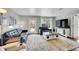 Bright living room featuring modern decor and a door to the backyard at 1303 S Danube Way # 104, Aurora, CO 80017