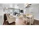Bright living room with hardwood floors, a ceiling fan, and a large window letting in natural light at 1303 S Danube Way # 104, Aurora, CO 80017