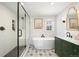 Modern bathroom with a standalone tub, glass-enclosed shower, and elegant fixtures at 2482 Otis Ct, Edgewater, CO 80214