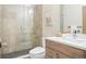 A bright bathroom with a seamless glass shower, modern vanity, and stylish fixtures offers a spa-like experience at 1415 Irving St, Denver, CO 80204