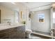 A modern bathroom features a glass-enclosed shower, stylish vanity, and contemporary finishes at 1415 Irving St, Denver, CO 80204