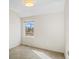 A bright, neutral bedroom features a large window providing natural light and views at 1415 Irving St, Denver, CO 80204