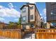 Modern home with brick and metal siding, a wooden fence, and a neatly landscaped yard at 1415 Irving St, Denver, CO 80204