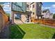Well-maintained front yard featuring green grass and a privacy fence surrounding the home at 1415 Irving St, Denver, CO 80204
