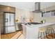 Bright kitchen featuring stainless steel appliances, a breakfast bar, and modern cabinetry at 1415 Irving St, Denver, CO 80204