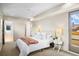 Bright main bedroom with large window, plush carpet, and en-suite bathroom at 1415 Irving St, Denver, CO 80204