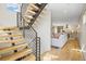 Staircase with wood treads and metal railings leading to an open-concept living area at 1415 Irving St, Denver, CO 80204