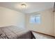 This bedroom features a gray comforter on the bed and a window with blinds at 6057 S Pierson St, Littleton, CO 80127