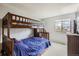 bedroom featuring bunk beds, carpeted floor, and a bright window view at 6057 S Pierson St, Littleton, CO 80127