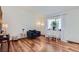 Bright living room with hardwood floors, a stylish blue armchair, and elegant decor at 6057 S Pierson St, Littleton, CO 80127
