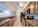 Kitchen with wood cabinets, stainless steel appliances, and a breakfast bar at 12093 W Cross Dr # 206, Littleton, CO 80127