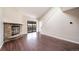 Bright living room with stone fireplace and hardwood floors at 12093 W Cross Dr # 206, Littleton, CO 80127