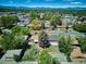 Lush neighborhood with tree-lined streets and mountain views under a bright blue sky at 1852 S Decatur St, Denver, CO 80219