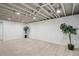 Finished basement with neutral carpet and exposed ceiling at 1852 S Decatur St, Denver, CO 80219