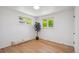 Bright bedroom featuring hardwood floors and two windows providing ample natural light at 1852 S Decatur St, Denver, CO 80219