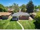 Charming brick home featuring a well-maintained lawn, a covered porch and mature trees in a peaceful neighborhood at 1852 S Decatur St, Denver, CO 80219