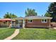 Single-story brick home with a well-maintained lawn and a walkway leading to the front door at 1852 S Decatur St, Denver, CO 80219