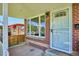 Inviting covered front porch highlighting brick detail, modern railing, and an exterior view of the surrounding neighborhood at 1852 S Decatur St, Denver, CO 80219