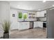 Modern kitchen with white cabinets, stainless steel appliances, subway tile backsplash, and sleek countertops at 1852 S Decatur St, Denver, CO 80219
