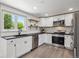 Stylish kitchen with white cabinetry, subway tile backsplash, stainless steel appliances, and modern fixtures at 1852 S Decatur St, Denver, CO 80219