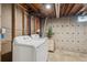 Unfinished basement laundry room with washer and dryer next to gray concrete walls at 1852 S Decatur St, Denver, CO 80219