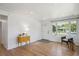 Sun-filled living room with hardwood floors, white walls, and views of the outdoors through a large window at 1852 S Decatur St, Denver, CO 80219