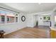 Bright living room featuring hardwood floors, white walls, and an open layout leading into the modern kitchen at 1852 S Decatur St, Denver, CO 80219