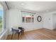 Bright, minimalist living room with beautiful hardwood floors and a cozy seating area by a large window at 1852 S Decatur St, Denver, CO 80219