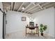 Basement office features a modern desk, chair, and plants at 1852 S Decatur St, Denver, CO 80219