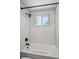 Shower and tub combo with white subway tile, a dark faucet and shower head at 1852 S Decatur St, Denver, CO 80219