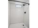 Bright white shower features a black shower head, faucet, and a window for natural light at 1852 S Decatur St, Denver, CO 80219