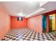 Finished basement with checkerboard floor, room for entertaining and storage at 7634 Navajo St, Denver, CO 80221