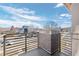 Balcony featuring brick accents and neighborhood views on a sunny day at 2053 Meade St, Denver, CO 80211
