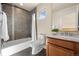 Bathroom with tiled shower, modern vanity, and natural light at 2053 Meade St, Denver, CO 80211