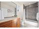Bathroom with modern vanity, large mirror, tiled shower, and bathtub combination at 2053 Meade St, Denver, CO 80211