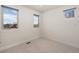 Bright bedroom with three windows showcasing the surrounding neighborhood at 2053 Meade St, Denver, CO 80211