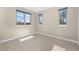 Bedroom with neutral carpet and three windows offering natural light and outdoor views at 2053 Meade St, Denver, CO 80211