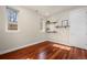 Bright bedroom featuring hardwood floors, neutral walls, and built-in shelving for decor at 2053 Meade St, Denver, CO 80211