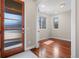 Inviting entryway featuring a stylish wood door with glass accents and gleaming hardwood floors at 2053 Meade St, Denver, CO 80211