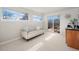 Living room with a sofa and access to a balcony and featuring a wet bar with a mini fridge at 2053 Meade St, Denver, CO 80211