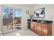 Living room area featuring access to balcony with a wet bar and mini fridge for entertaining at 2053 Meade St, Denver, CO 80211