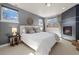 Comfortable bedroom with multiple windows, neutral walls, and a cozy fireplace at 2053 Meade St, Denver, CO 80211