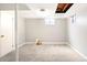 Bright basement showcasing neutral carpet and walls, with a window for natural light at 6156 W Jefferson Ave, Denver, CO 80235