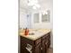 Bathroom featuring a wood vanity with a decorative countertop and a sink at 6156 W Jefferson Ave, Denver, CO 80235