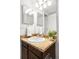 Close-up of a bathroom sink with a brown granite counter and a decorative plant at 6156 W Jefferson Ave, Denver, CO 80235